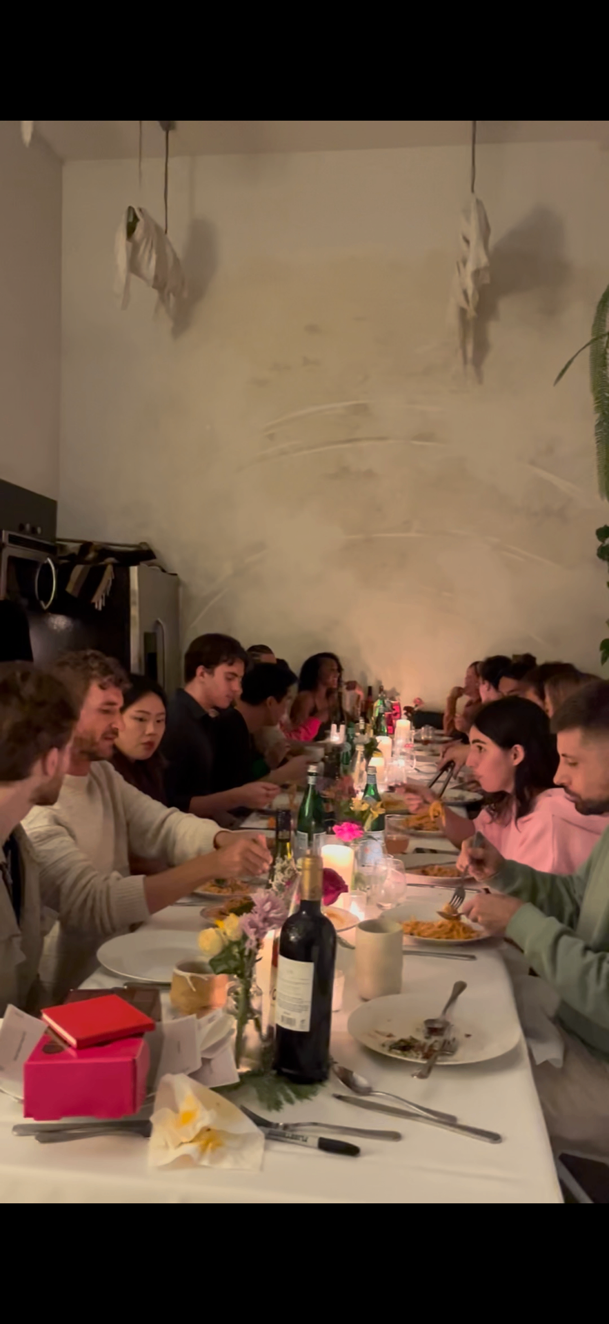 Overhead view of a candlelit communal dinner during a Frontier NYC event